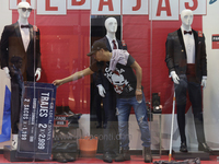 A person is fixing a display in downtown Mexico City.

After Mexico City reached a record temperature of 34.2 degrees Celsius in recent mont...