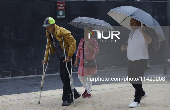 A view of passers-by in the centre of Mexico City, Mexico, on Monday, after Mexico City is reaching a record temperature of 34.2 degrees Cel...