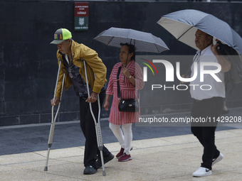 A view of passers-by in the centre of Mexico City, Mexico, on Monday, after Mexico City is reaching a record temperature of 34.2 degrees Cel...