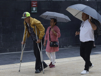 A view of passers-by in the centre of Mexico City, Mexico, on Monday, after Mexico City is reaching a record temperature of 34.2 degrees Cel...