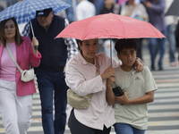 A view of passers-by in the centre of Mexico City, Mexico, on Monday, after Mexico City is reaching a record temperature of 34.2 degrees Cel...