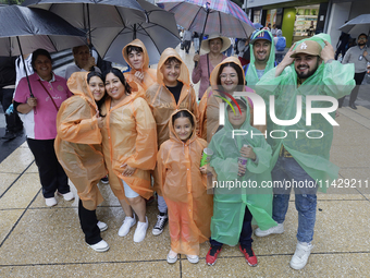 Passers-by are taking shelter in the centre of Mexico City, Mexico, on Monday, after the city reached a record temperature of 34.2 degrees C...