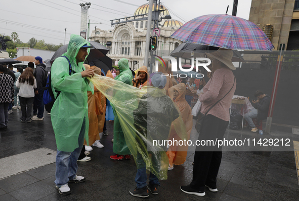 Passers-by are taking shelter in the centre of Mexico City, Mexico, on Monday, after the city reached a record temperature of 34.2 degrees C...