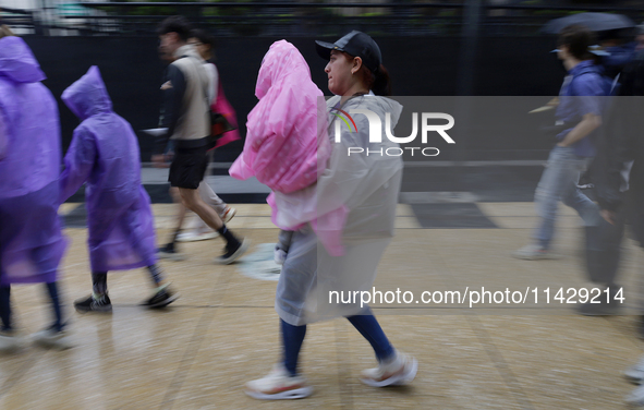 Passers-by are taking shelter in the centre of Mexico City, Mexico, on Monday, after the city reached a record temperature of 34.2 degrees C...