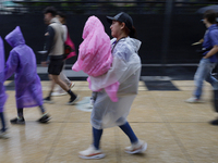 Passers-by are taking shelter in the centre of Mexico City, Mexico, on Monday, after the city reached a record temperature of 34.2 degrees C...