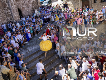 The dancers are descending in Anguiano, Spain, on July 22, 2024. (