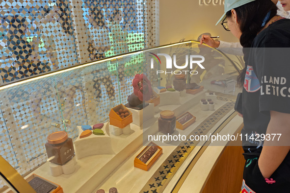 Visitors are shopping at Louis Vuitton's first chocolate store in Shanghai, China, on July 23, 2024. 