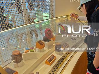 Visitors are shopping at Louis Vuitton's first chocolate store in Shanghai, China, on July 23, 2024. (