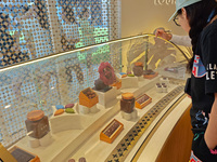 Visitors are shopping at Louis Vuitton's first chocolate store in Shanghai, China, on July 23, 2024. (