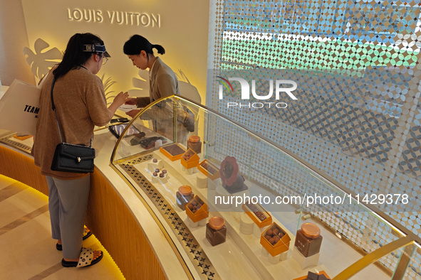 Visitors are shopping at Louis Vuitton's first chocolate store in Shanghai, China, on July 23, 2024. 