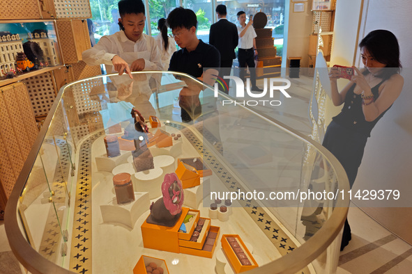 Visitors are shopping at Louis Vuitton's first chocolate store in Shanghai, China, on July 23, 2024. 