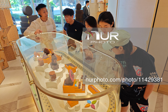 Visitors are shopping at Louis Vuitton's first chocolate store in Shanghai, China, on July 23, 2024. 