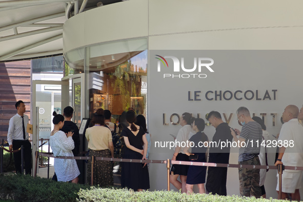 Tourists are lining up at Louis Vuitton's first chocolate store in Shanghai, China, on July 23, 2024. 