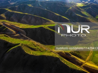 Workers are installing and inspecting a coal transport corridor on Road 147 in Hutubi County, Changji Hui Autonomous Prefecture, Xinjiang, C...