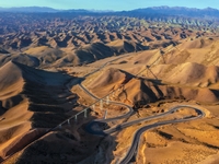 Workers are installing and inspecting a coal transport corridor on Road 147 in Hutubi County, Changji Hui Autonomous Prefecture, Xinjiang, C...