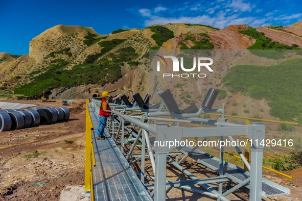 Workers are installing and inspecting a coal transport corridor on Road 147 in Hutubi County, Changji Hui Autonomous Prefecture, Xinjiang, C...