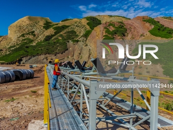 Workers are installing and inspecting a coal transport corridor on Road 147 in Hutubi County, Changji Hui Autonomous Prefecture, Xinjiang, C...