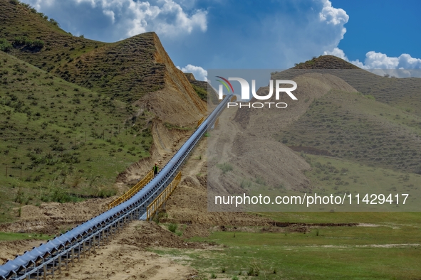 Workers are installing and inspecting a coal transport corridor on Road 147 in Hutubi County, Changji Hui Autonomous Prefecture, Xinjiang, C...