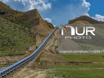 Workers are installing and inspecting a coal transport corridor on Road 147 in Hutubi County, Changji Hui Autonomous Prefecture, Xinjiang, C...