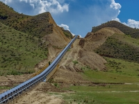 Workers are installing and inspecting a coal transport corridor on Road 147 in Hutubi County, Changji Hui Autonomous Prefecture, Xinjiang, C...