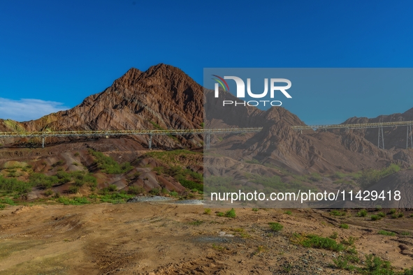 Workers are installing and inspecting a coal transport corridor on Road 147 in Hutubi County, Changji Hui Autonomous Prefecture, Xinjiang, C...