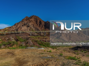 Workers are installing and inspecting a coal transport corridor on Road 147 in Hutubi County, Changji Hui Autonomous Prefecture, Xinjiang, C...