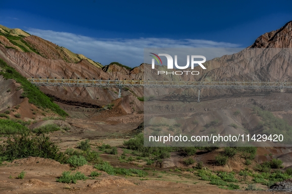 Workers are installing and inspecting a coal transport corridor on Road 147 in Hutubi County, Changji Hui Autonomous Prefecture, Xinjiang, C...