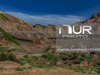 Workers are installing and inspecting a coal transport corridor on Road 147 in Hutubi County, Changji Hui Autonomous Prefecture, Xinjiang, C...