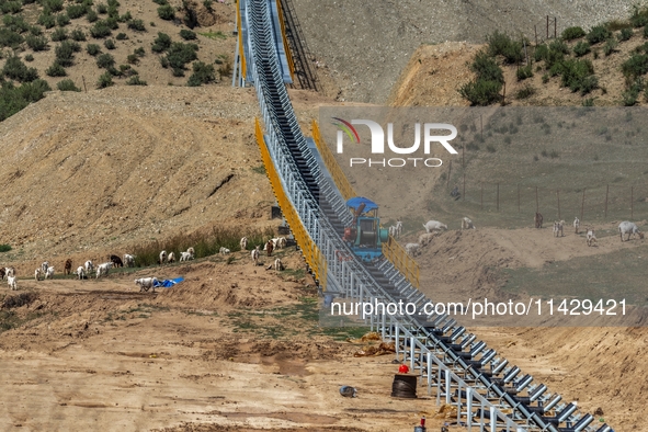 Workers are installing and inspecting a coal transport corridor on Road 147 in Hutubi County, Changji Hui Autonomous Prefecture, Xinjiang, C...