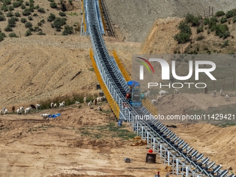 Workers are installing and inspecting a coal transport corridor on Road 147 in Hutubi County, Changji Hui Autonomous Prefecture, Xinjiang, C...