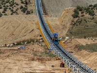 Workers are installing and inspecting a coal transport corridor on Road 147 in Hutubi County, Changji Hui Autonomous Prefecture, Xinjiang, C...