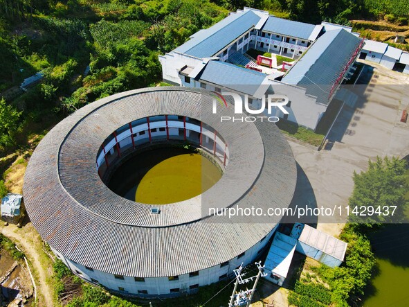 A square building and a round building are being seen in Maojianshan township, Yuexi County, in Anqing, China, on July 22, 2024. 