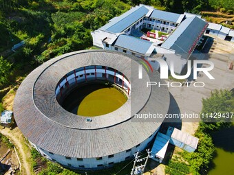 A square building and a round building are being seen in Maojianshan township, Yuexi County, in Anqing, China, on July 22, 2024. (