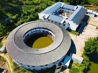 A square building and a round building are being seen in Maojianshan township, Yuexi County, in Anqing, China, on July 22, 2024. (