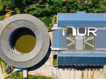 A square building and a round building are being seen in Maojianshan township, Yuexi County, in Anqing, China, on July 22, 2024. (