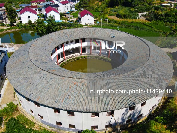 A square building and a round building are being seen in Maojianshan township, Yuexi County, in Anqing, China, on July 22, 2024. 