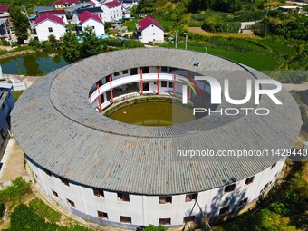 A square building and a round building are being seen in Maojianshan township, Yuexi County, in Anqing, China, on July 22, 2024. (