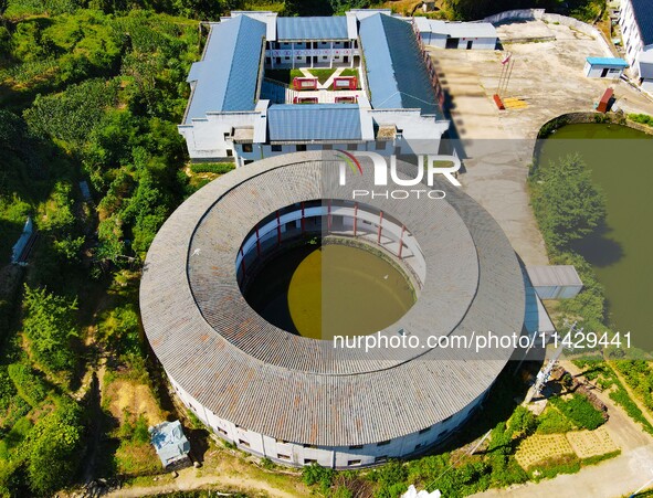 A square building and a round building are being seen in Maojianshan township, Yuexi County, in Anqing, China, on July 22, 2024. 