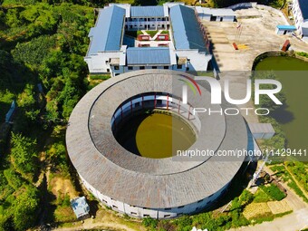 A square building and a round building are being seen in Maojianshan township, Yuexi County, in Anqing, China, on July 22, 2024. (