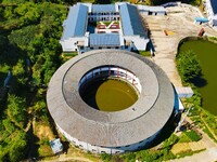 A square building and a round building are being seen in Maojianshan township, Yuexi County, in Anqing, China, on July 22, 2024. (