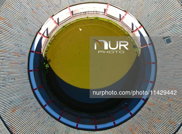 A square building and a round building are being seen in Maojianshan township, Yuexi County, in Anqing, China, on July 22, 2024. 