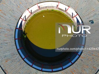 A square building and a round building are being seen in Maojianshan township, Yuexi County, in Anqing, China, on July 22, 2024. (