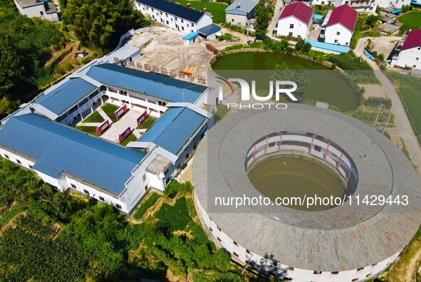 A square building and a round building are being seen in Maojianshan township, Yuexi County, in Anqing, China, on July 22, 2024. 