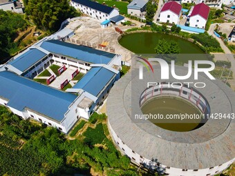 A square building and a round building are being seen in Maojianshan township, Yuexi County, in Anqing, China, on July 22, 2024. (