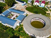 A square building and a round building are being seen in Maojianshan township, Yuexi County, in Anqing, China, on July 22, 2024. (