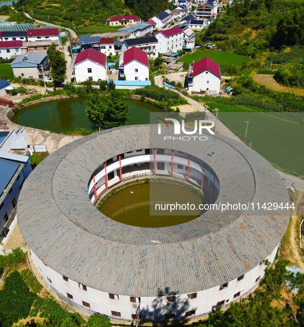 A square building and a round building are being seen in Maojianshan township, Yuexi County, in Anqing, China, on July 22, 2024. 