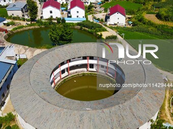 A square building and a round building are being seen in Maojianshan township, Yuexi County, in Anqing, China, on July 22, 2024. (