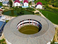 A square building and a round building are being seen in Maojianshan township, Yuexi County, in Anqing, China, on July 22, 2024. (