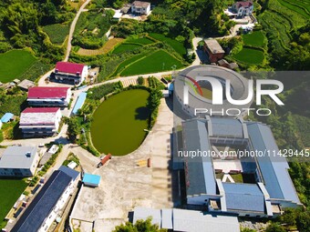 A square building and a round building are being seen in Maojianshan township, Yuexi County, in Anqing, China, on July 22, 2024. (