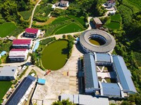 A square building and a round building are being seen in Maojianshan township, Yuexi County, in Anqing, China, on July 22, 2024. (